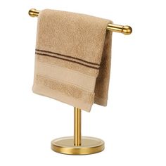 a gold towel rack with two towels on it and one folded in the same color