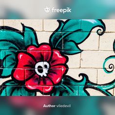 a painted flower on the side of a brick wall that reads, freepik