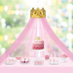 a pink cake and cupcakes on a table with a princess canopy in the background