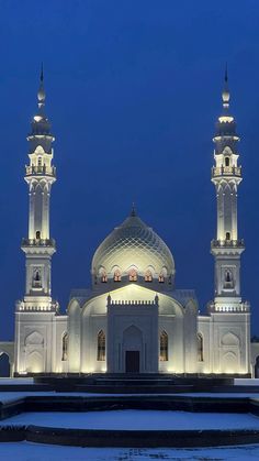 a large white building with two towers lit up at night