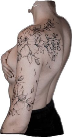 the back of a man's body with flowers tattooed on his arm and shoulder