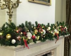 a mantel decorated with christmas decorations and lights