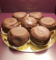 chocolate cupcakes sitting on top of a gold plate