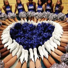 a group of cheerleaders sitting in a circle