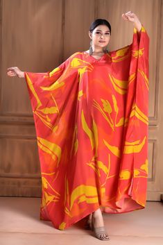 Make a statement in this bold and beautiful V-neck red silk caftan. Crafted from premium silk, this luxurious caftan features a flattering V-neckline that accentuates the décolletage and adds a touch of sophistication. The flowing silhouette drapes elegantly on the body, providing both comfort and style. Whether worn to a formal event or a casual gathering, this red silk caftan is sure to turn heads and make a lasting impression. Step out in confidence and showcase your unique sense of style wit Elegant V-neck Kaftan For Vacation, Red Maxi Length Kaftan For Spring, Silk Kaftan For Evening, Elegant Silk Kaftan For Vacation, Orange Silk Dress For Eid, Red Kaftan With Kimono Sleeves For Vacation, Bohemian Silk Kaftan For Evening, Silk V-neck Kaftan For Vacation, Red Silk Kaftan For Vacation