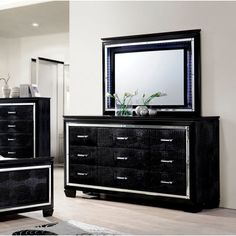 a black dresser and mirror in a room