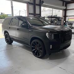 a black suv is parked in a garage