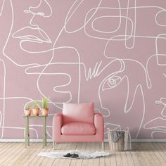 a pink chair sitting in front of a wall with white lines on it and a potted plant