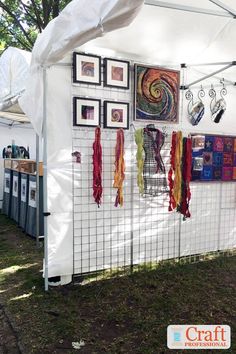 a white tent with pictures hanging on it