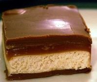 a close up of a piece of cake on a white plate with chocolate frosting