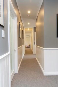 the hallway is clean and ready for guests to use it as an entrance way in this home