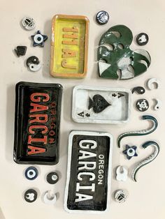 several different types of buttons and magnets on a white surface with the word gargola written below them