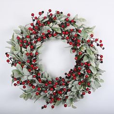 a wreath with red berries and green leaves