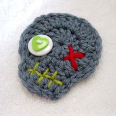 there is a crocheted object with buttons on it