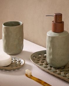 a toothbrush and soap dispenser sitting on a table next to each other