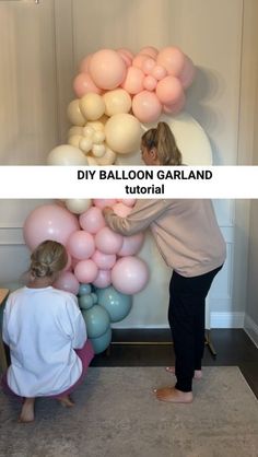 two women standing next to each other with balloons on the wall in front of them