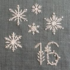 snowflakes are shown on the tablecloth, and numbers are written in white thread