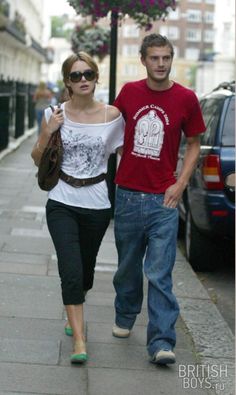 a man and woman walking down the street