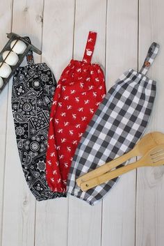 three kitchen gadgets laid out on a white wooden surface