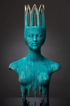 a blue statue with two forks sticking out of it's head