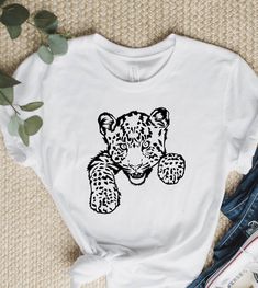 "Leopard Shirt, Animal Lovers Shirt, Baby Leopard, Gift for Men and Women, Inspirational Shirt, Cute Animals, Peeking Leopard, Animal Gift. WELCOME TO \"GoldenShirtDesign\" ! High quality and super soft, comfortable shirt. Made with top of the line vinyl and pressed with a professional grade heat press. All our simple color ones like White, Black, and Red are 100% Cotton. All our Heathered Colors are cotton/polyester blend and they are super comfy soft! SIZING AND COLORS Make sure you check our Unisex White Printed Tops, Unisex Printed White Tops, Unisex White Shirt With Funny Print, White Printed Tops, Animal Clothing, Camping Shirts, Baby Leopard, Leopard Shirt, Leopard Animal