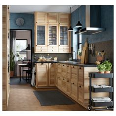 a kitchen with blue walls and wooden cabinets