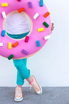 a person holding a giant donut shaped like a doughnut