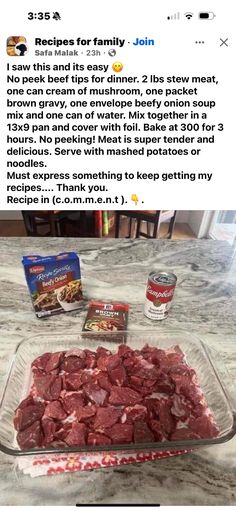 a glass dish filled with meat sitting on top of a counter next to two packages of food