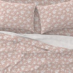 an image of a bed with floral sheets and pillowcases on top of it