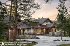 a large house with lots of trees in the front yard and walkway leading to it