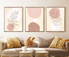 a living room with two couches and paintings on the wall above them, along with a coffee table