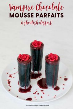 three chocolate mousse parfaits on a plate with blood dripping down the side