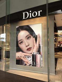 a dior ad on the front of a store