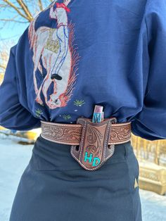 a person wearing a blue shirt with a horse design on it's back pocket