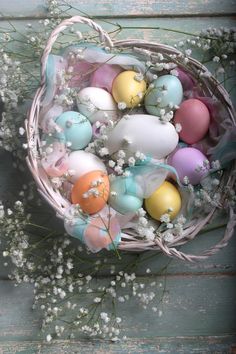 an easter basket filled with eggs and baby's breath