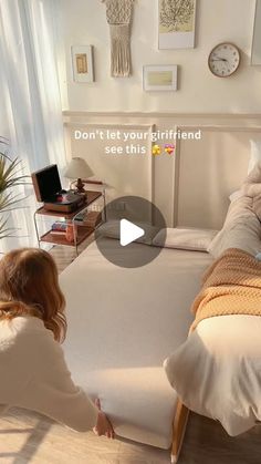 a woman sitting on a bed in front of a white headboard and foot board