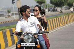 a man riding on the back of a motorcycle next to a woman