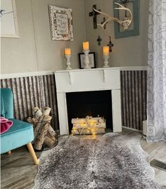 a living room filled with furniture and a fire place in front of a white fireplace