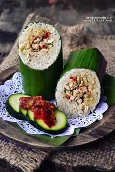 rice wrapped in banana leaves and topped with sauce