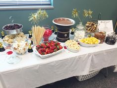 a table topped with lots of food and desserts