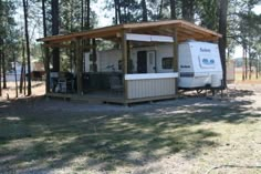 a mobile home sits in the middle of a wooded area