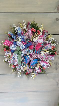 a wreath made out of paper flowers and butterflies