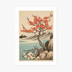 a tree with red leaves on it in front of a body of water and mountains