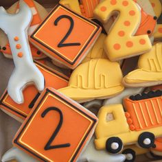 decorated cookies in the shape of numbers and construction vehicles