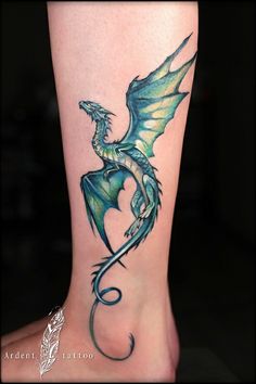 a green dragon tattoo on the leg