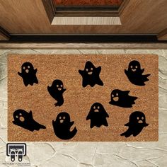 a door mat with black ghost silhouettes on it