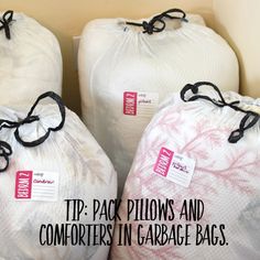 three bags with tags on them sitting next to each other and the words tip - pack pillows and comforters in garage bags