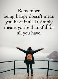 a woman with her arms outstretched standing on a railing looking at the ocean and saying,'remember, being happy doesn't mean you have it all it