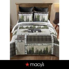 a bed with a bear and trees on it