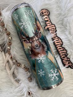 thermos cup is decorated with snowflakes and a deer's head